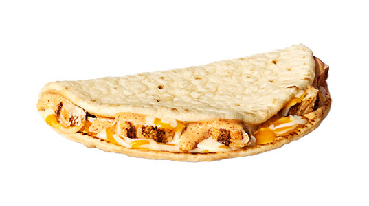 A taco-shaped object filled with chicken chunks and cheese.