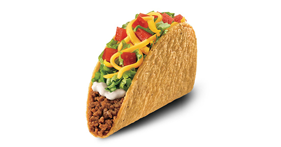 A hard shell taco filled with ground beef, sour cream, lettuce, cheese, and diced tomato.