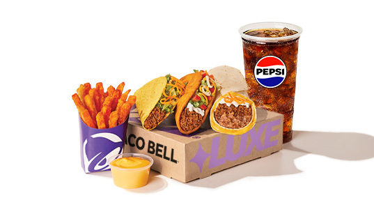 A beef and cheese burrito, a Dorito taco, a regular taco, french fries with cheese sauce, and a cup of soda.