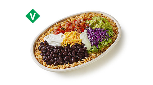 A burrito bowl filled with rice and topped with black beans, lettuce, purple cabbage, pico de gallo, sour cream, and cheese.