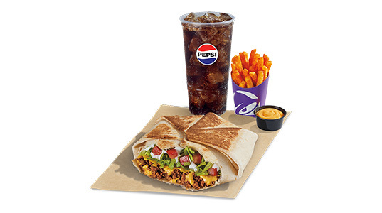 A hexagonal folded tortilla sandwich filled with beef, cheese sauce, lettuce, tomato, and sour cream, with a side of fries and cheese sauce plus a soda.