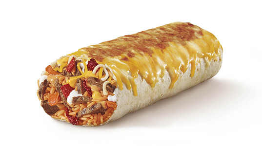 A burrito filled with rice, steak chunks, cheese, tomato, and sour cream. It has cheese melted and slightly caramelized on top of it.