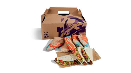 A box filled with 8 soft shell tacos. These ones have tomato in them, which makes them supreme.